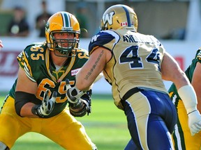 EDMONTON, ALTA: /September/ 14, 2013 --Simeon Rottier #65 protects the quarterback as the Edmonton Eskimos battle the Winnipeg Blue Bombers at Commonwealth stadium in Edmonton, September 14, 2013.