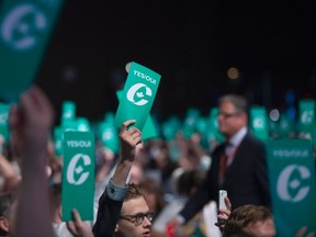 Delegates raise their yes vote cards to change the wording of the traditional definition of marriage in the conservative policies at the Conservative Party of Canada convention in Vancouver, Saturday, May 28, 2016. THE CANADIAN PRESS/Jonathan Hayward