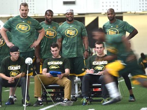 A day before opening day of training camp, Eskimos watch teammate Deion Belue in the shuttle run testing during the players medicals at Commonwealth Rec Centre fieldhouse in Edmonton on Saturday.