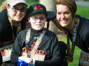 L-R 14 year old Noemy Pitre, Jonathan Pitre and mother Tina Boileau after finishing the 5K race part of Tamarack Ottawa Race Weekend Saturday May 28, 2016.