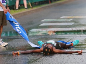 Peres Jepchirchir of Kenya collapses after winning the Ottawa 10K women’s race. (Jana Chytilova/Postmedia Network)