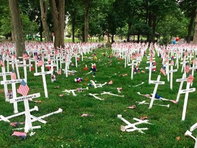 This photo provided by the Henderson Police Department shows a Memorial Day display of crosses after a vehicle drove through them in Henderson, Ky.'s Central Park on Saturday, May 28, 2016. The display honours the names of more than 5,000 from the city and county of Henderson who served in conflicts dating back to the Revolutionary War. (Joe Whitledge/Henderson Police Department via AP)