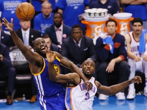 Golden State Warriors forward Draymond Green (23) and Oklahoma City Thunder forward Serge Ibaka (9) go after a loose ball during Game 6 of the NBA Western Conference final in Oklahoma City Saturday, May 28, 2016. (AP Photo/Sue Ogrocki)