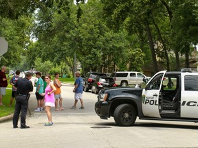 Police block the intersection at Wycliffe and Apple Tree as they respond to a shooting where authorities say a gunman and at least one other person are dead, Sunday, May 29, 2016, in Houston. (Gary Fountain/Houston Chronicle via AP)