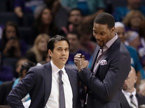 Miami Heat head coach Erik Spoelstra talks with Chris Bosh during the second half in Game 4 of an NBA playoff first-round series against the Charlotte Hornets in Charlotte on April 25, 2016. (AP Photo/Chuck Burton)