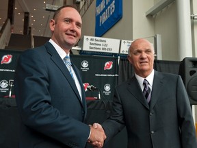 Peter DeBoer shakes hands with New Jersey Devils GM Lou Lamoriello after at a news conference where he was named the team's new head coach in Newark, N.J., on July 19, 2011. (REUTERS/Ray Stubblebine)