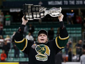 Max Jones hoists the memorial Cup over his head following the London Knights victory Sunday in Red Deer. (Getty Images)