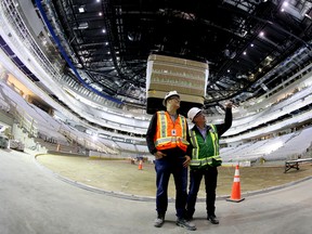 Katz Group executive vice-president Bob Black, left, and executive director of the Downtown Arena Project Rick Daviss look at the interior of the under construction Rogers Place arena Sunday. (David Bloom)