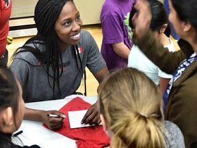 Forward Tamara Tatham from Canada's Basketball Senior Women’s National Team signs autographs for students from four schools at the Saville Centre in Edmonton on Friday. (Ed Kaiser)