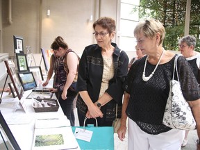 Ellenor and Laurianne Valiquette check out some art work at the Art of Tea in Sudbury, Ont. on Sunday May 29, 2016. The event was a fundraiser for White Owl Residence, an Alzheimer's group home scheduled to open in 2018. Gino Donato/Sudbury Star/Postmedia Network