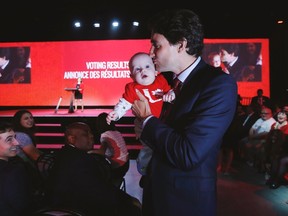 Prime Minister Justin Trudeau takes holds six-month-old Finn Lipka prior to the closing ceremonies of the 2016 Liberal Biennial Convention Winnipeg Saturday, May 28, 2016. THE CANADIAN PRESS/John Woods