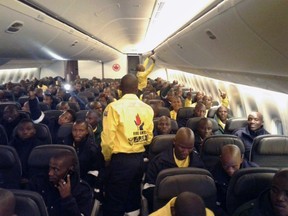 South African firefighters are seen on a an Air Canada plane in Johannesburg, South Africa destined for Edmonton on Sunday May 29, 2016 in this handout photo. Air Canada is flying 300 firefighters from Johannesburg, South Africa to assist with Alberta wild fires. THE CANADIAN PRESS/HO-CNW Group