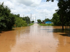 Sixth Street is impassible due to rising flood waters from the Brazos River Sunday, May 29, 2016, in Rosenberg, Texas. (Jon Shapley/Houston Chronicle via AP)