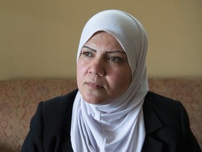 Noor Al Jawabreh, a refugee from Syria, sits in her home in Kitchener, Ont. on Sunday, May 29, 2016. Al Jawabreh believed her niece, whom she thought saw in a photo, was still alive but recently found out it was not her niece. She now believes her niece may have died along with the many others in a boat disaster near Italy. THE CANADIAN PRESS/Hannah Yoon