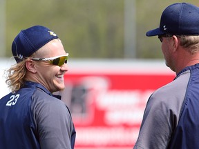 Winnipeg Goldeyes outfielder Josh Romanski (left) chats with manager Rick Forney during American Association baseball practice in Winnipeg, Man. Sunday May 08, 2016.