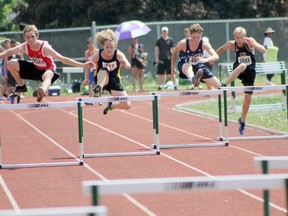 Woodstock Collegiate's Jakob Ager, left, leaps over a hurdle in the midget boys' 300m hurdles at OFSAA West Regionals at Jacob Hespeler Secondary School in Cambridge last weekend. Oxford County will have 12 athletes advance to OFSAA track and field in 14 events finals June 2 to 4 at the University of Windsor. (Submitted photo)