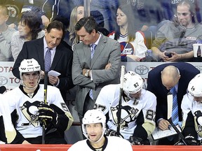 Penguins head coach Mike Sullivan (centre) listens to assistant coach Jacques Martin while assistant Rick Tocchet (right) speaks with Sidney Crosby (87) and Chris Kunitz during a break in play against the Jets in Winnipeg on Dec. 27, 2015. (Kevin King/Postmedia Network)