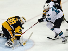 Penguins goalie Matt Murray (left) stops a shot by Sharks forward Tomas Hertl (right) during second period action in Game 1 of the Stanley Cup final in Pittsburgh on Monday, May 30, 2016. (Gene J. Puskar/AP Photo)