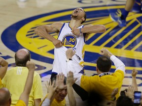 Fans cheer as Warriors guard Stephen Curry yells after beating the Thunder in Game 7 of the NBA's Western Conference final in Oakland, Calif., on Monday, May 30, 2016. (Ben Margot/AP Photo)