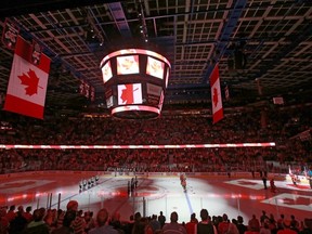 The interior of the Scotiabank Saddledome is lit up for the Canadian anthem in Calgary, Alta., in this Sept. 29, 2015 file photo. (Jim Wells/Calgary Sun/Postmedia Network)