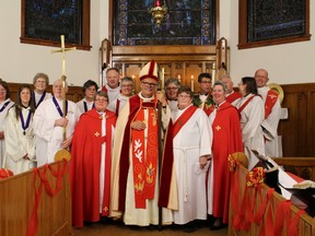 Members of the clergy, and choir join the newly ordained Deacon: Rev. Edith Belair.