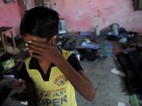 This file photo taken on November 10, 2009 shows an Indian bonded child labourer crying during a raid and rescue operation conducted by the Bachpan Bachao Andolan (Save the Childhood Movement) in New Delhi. 
More than 45 million men, women and children globally are trapped in modern slavery, far more than previously thought, with two-thirds in the Asia-Pacific, a study showed May 31, 2016. AFP Photo/Manan Vatsyayana