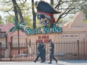 OPP officers perform a ground search near a mini-golf course in Wasaga Beach, Tuesday, after the body of 23-year-old Erick Tello Arias, of Caledon, was found early Monday morning. Arias' fatal stabbing was the second in two days after Francesco Molinaro, 18, also of Caledon, was found early Sunday morning with fatal stab wounds. 
J.T. McVeigh/Postmedia Network