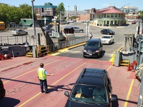 Vehicles drive onto the Wolfe Islander III at the Kingston ferry terminal. (Elliot Ferguson/The Whig-Standard)