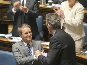 Manitoba finance minster Cameron Friesen  (l) is congratulated by Premier Brian Pallister after delivering Budget 2016 in Winnipeg, Man. Tuesday May 31, 2016.
Brian Donogh/Winnipeg Sun/Postmedia Network