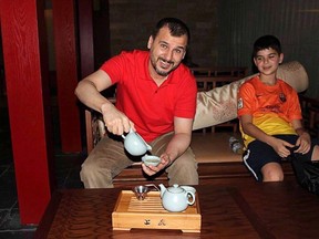 Canadian Salim Alaradi, left, and his son, Mohamed Alaradi are shown on a family vacation in the United Arab Emirates in a 2013 family handout photo. The family of Alaradi, a Canadian acquitted of charges he faced in the United Arab Emirates,  says the man has been released from prison after nearly two years behind bars. THE CANADIAN PRESS/HO, File