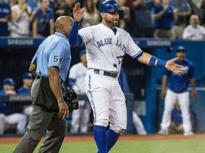 Blue Jays base runner Kevin Pillar jumps up and celebrates after sliding home at the plate to put the Jays ahead 4-1 against Yankees during seventh inning MLB action in Toronto on Tuesday, May 31, 2016. (Craig Robertson/Toronto Sun)