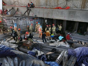 Rescue workers search for survivors after an explosion at a subway construction site in Namyangju, South Korea, Wednesday, June 1, 2016. Officials from the Gyeonggi Province Fire and Disaster Headquarters said the workers were underground when the explosion occurred Wednesday morning. (Lim Byung-shick/Yonhap via AP)