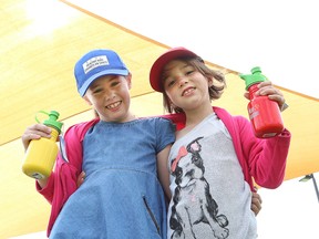 Ecole St-Denis students Ayvangelie Levy, 7, left, and Addison Sauve, 7, were on hand for the unveiling of a sun shade at James Jerome Sports Complex in Sudbury, Ont. on Tuesday May 31, 2016. John Lappa/Sudbury Star/Postmedia Network