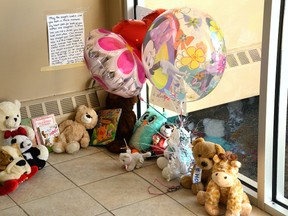 A collection of stuffed animals and balloons on Friday October 23, 2015 in the lobby of an Arbour Glen Cres. apartment building where a 6-year-old girl was stabbed the day before. File photo/MORRIS LAMONT/THE LONDON FREE PRESS/