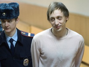 This file photo taken on December 3, 2013 shows Bolshoi soloist Pavel Dmitrichenko, escorted in court in Moscow, within his trial for masterminding an acid attack on the troupe's artistic director. 
Dmitrichenko has been released on parole, has been granted parole and is already "back at home in Moscow," his lawyer Sergei Kadyrov told TASS news agency on May 31, 2016. AFP PHOTO / ALEXANDER NEMENOV