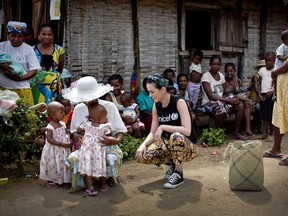This file photo released by UNICEF on April 7, 2013 shows US singer Katy Perry talking to twin girls while on a visit on April 6 to a nutritional centre in the village of Androranga Vola, Madagascar. Perry is now travelling with UNICEF in Vietnam. (UNICEF / KATE HOLT)