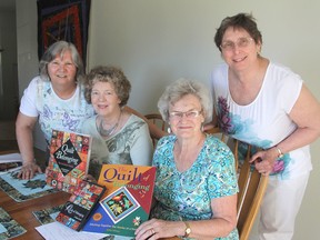 Simone Lynch, left, Marilyn Vance, Gail Jennings and Donna Hamilton, in Kingston, are members of the Kingston Heirloom Quilters, which helped create a massive quilt more than 10 years ago. The quilt is finally to be displayed in Kingston in June. (Michael Lea/The Whig-Standard)