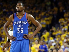 Oklahoma City Thunder's Kevin Durant watches during the closing minutes of the second half in Game 5 of the NBA basketball Western Conference finals against the Golden State Warriors in Oakland, Calif.  (AP Photo/Marcio Jose Sanchez, File)