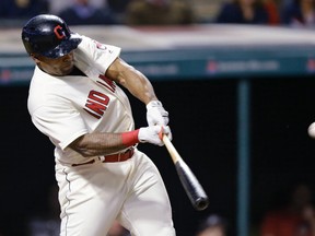 Cleveland Indians outfielder Marlon Byrd hits a two-run double off Minnesota Twins reliever Trevor May Friday, May 13, 2016, in Cleveland. (AP Photo/Tony Dejak)