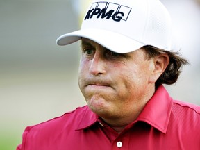 Phil Mickelson reacts after making double bogey on the 17th hole during the first round of the Memorial golf tournament in Dublin, Ohio. (AP Photo/Jay LaPrete, File)