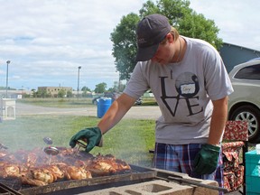 SAMANTHA REED/The Intelligencer
Volunteer Cory Loner works to barbecue some of the 1,800 half chickens that were up for grabs at the annual Kiwanis chicken barbecue at the Quinte Curling Club near the Exhibition Fairgrounds in Belleville on Wednesday.