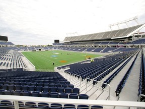 Grounds crew work on the football field at the new Citrus Bowl stadium in Orlando, Fla. (AP Photo/John Raoux, File)