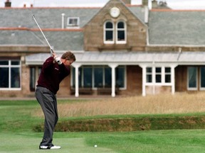 Scotland's Colin Montgomerie drives towards the clubhouse at Royal Troon, his home club, during a practice round before the British Open.