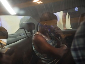 Rai de Souza, 22, a gang rape suspect is taken inside a police car to the police headquarters in Rio de Janeiro, Brazil, Monday, May 30, 2016. Police are searching for the more than 30 men suspected in the gang rape of a 16-year-old girl, a case that has rocked Latin America's largest nation and highlighted its endemic problem of violence against women. (AP Photo/Felipe Dana)