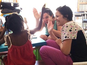 Nursing student Nicole McVittie, right, and Lambton College faculty member Rochelle Roberts play an interactive game with a child at La Maison, a respite centre for children with disabilities in Haiti. The visit was part of a recent awareness trip for nursing students at Lambton. (Handout)
