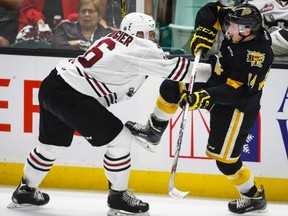 Brandon Wheat Kings' Ty Lewis, right, is knocked off his feet by Red Deer Rebels' Nelson Nogier during third period CHL Memorial Cup hockey action in Red Deer, Wednesday, May 25, 2016.THE CANADIAN PRESS/Jeff McIntosh