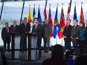 Prime Minister Justin Trudeau, centre, addresses the media during a news conference following the First Ministers Meeting in Vancouver, B.C., Thursday, March. 3, 2016. THE CANADIAN PRESS/Jonathan Hayward