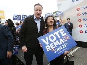 British Prime Minister David Cameron poses with a campaigner as he makes a joint appearance with Mayor of London Sadiq Khan (not seen) to launch the Britain Stronger in Europe guarantee card at Roehampton University on May 20, 2016 in London, United Kingdom. The 'guarantee card' lists five pledges should Britain remain in the EU, including the protection of workers' rights, full access to the single market and stability for Britain. U.K voters go to the polls on June 23 to vote in a referendum on the continued membership of the UK in the European Union. (Photo by Yui Mok - WPA Pool/Getty Images)