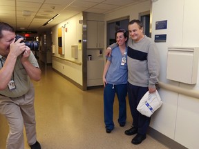 Thomas Manning, of Halifax, Mass., poses with nurse Ashley DiPaolo for hospital photographer Sam Riley as he prepares to be discharged from Massachusetts General Hospital, Wednesday, June 1, 2016, in Boston. Manning is the first man in the United States to undergo a penis transplant. (AP Photo/Elise Amendola)