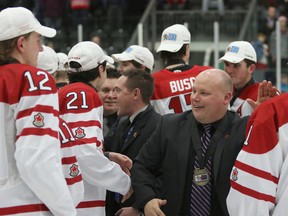 Team Canada West coach Tim Fragle (right) celebrates with his team. Canada West beat Russia 2-1 in the gold medal game at the 2015 World Junior A Challenge at the Cobourg last December. (Postmedia Network)
